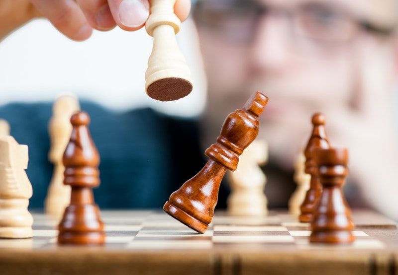 Person playing chess | competitor analysis | VIEWS Digital Marketing