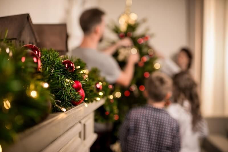Family decorating Christmas tree in house | favorite holiday traditions | VIEWS Digital Marketing