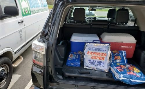 Trunk of supplies next to community center van | VIEWS Digital Marketing