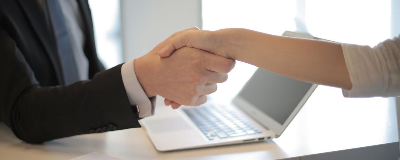 Business man and woman shaking hands at desk | Digital Marketing Consultant | VIEWS Digital Marketing