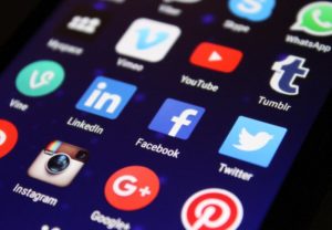 Phone with social media apps in menu | State of Paid Online Advertising | VIEWS Digital Marketing