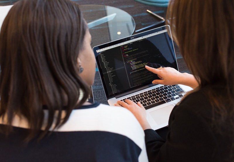 women at computer desk code